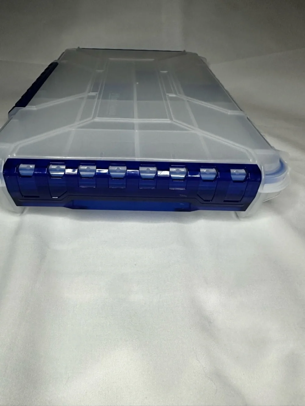 Multi-Compartment Clear Plastic Storage Box with Blue Accents.